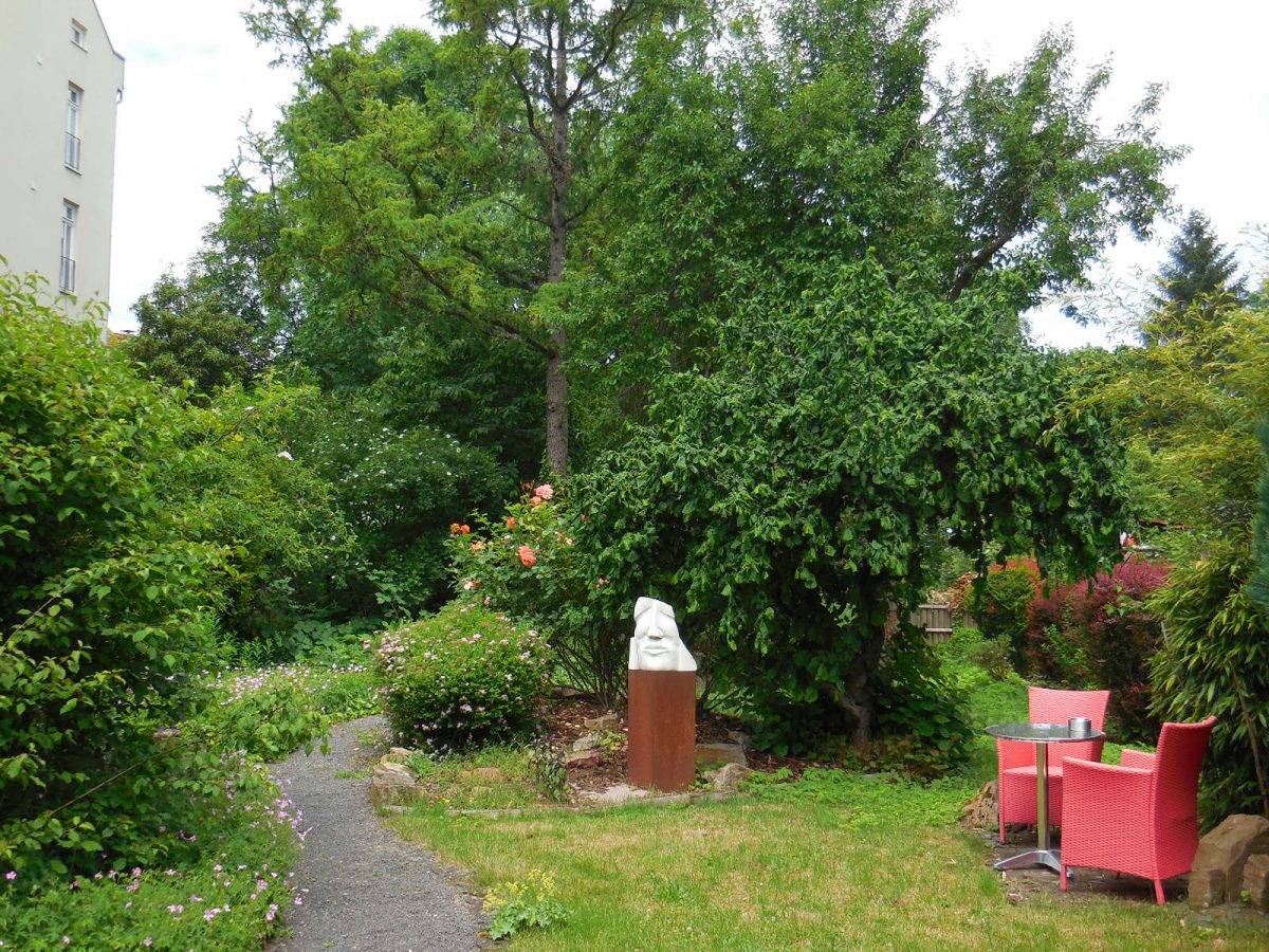 Blick in den hinteren Teil des Gartens mit Skulptur